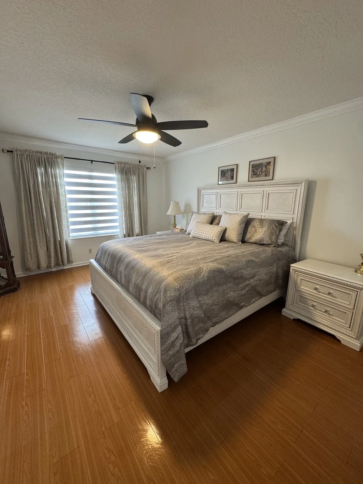 Clean bedroom with fresh white bedding after regular house cleaning